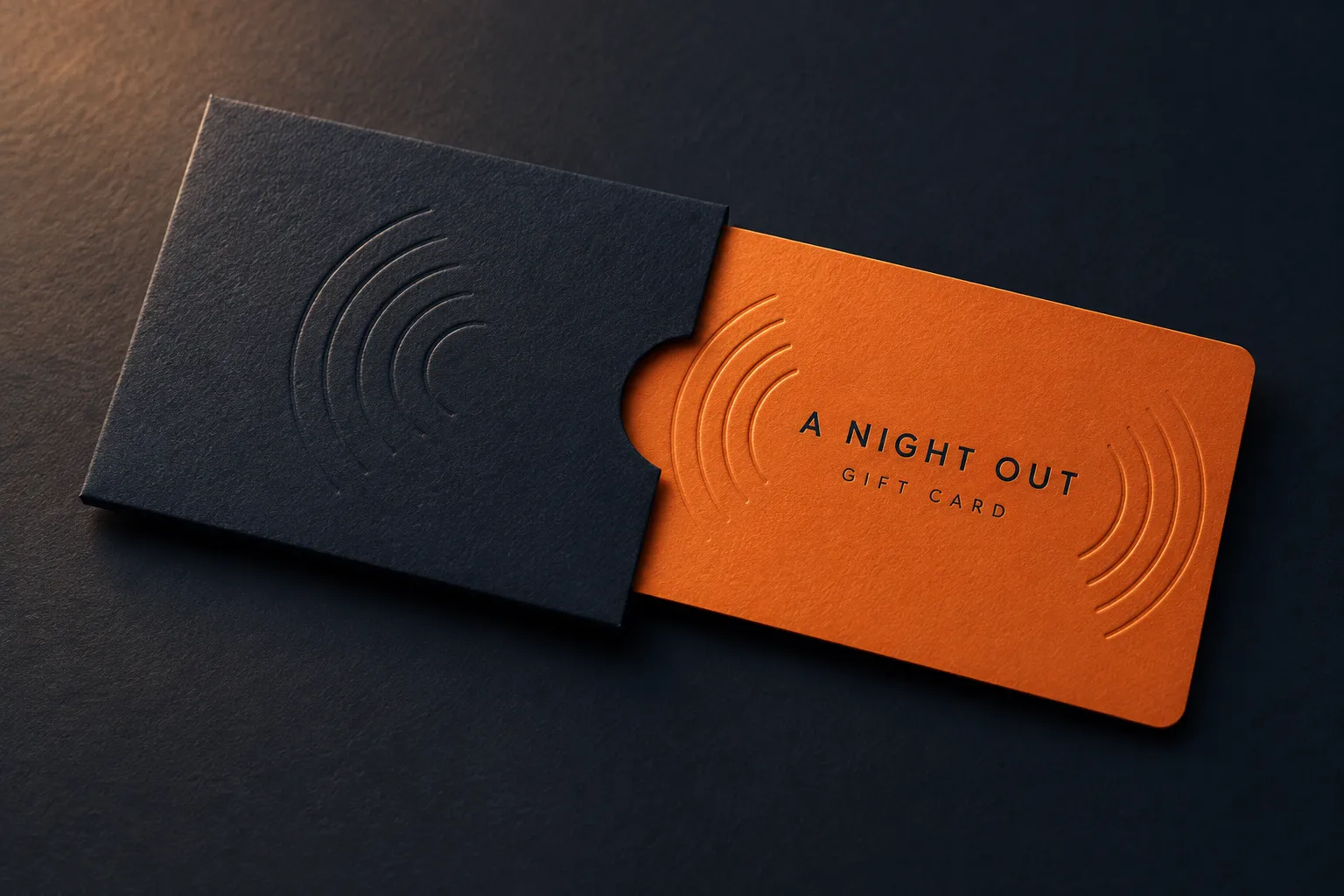 Orange A Night Out gift card sliding out of a navy sleeve.